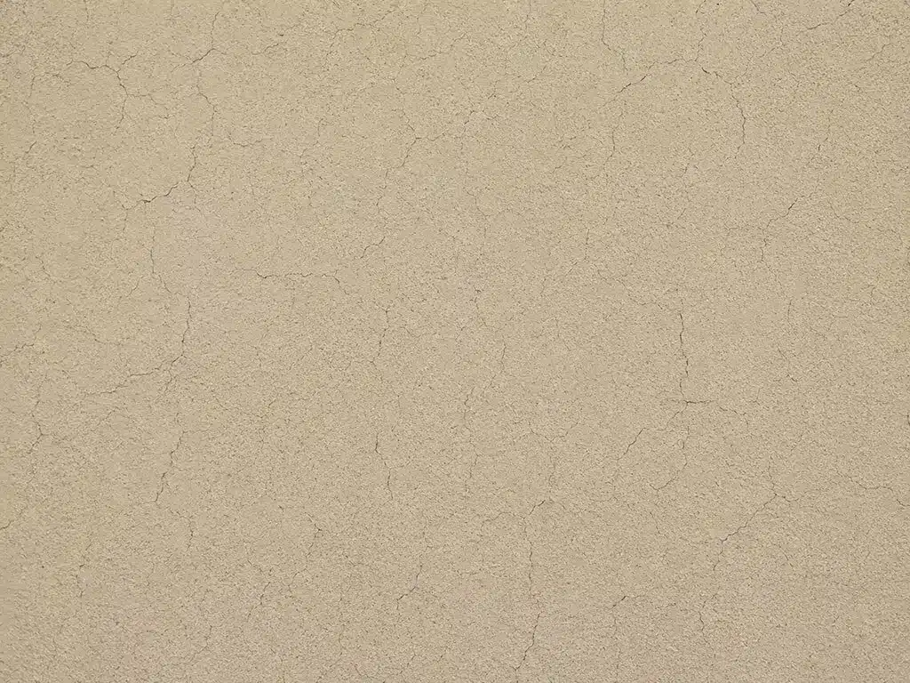 Faïençage : réseau de microfissures superficielles sur un enduit